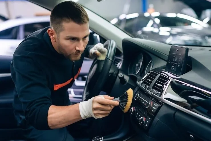 cleaning-with-brush-detergent-air-dashboard-multimedia-car-worker-detailing-au_926199-2894044-740x600